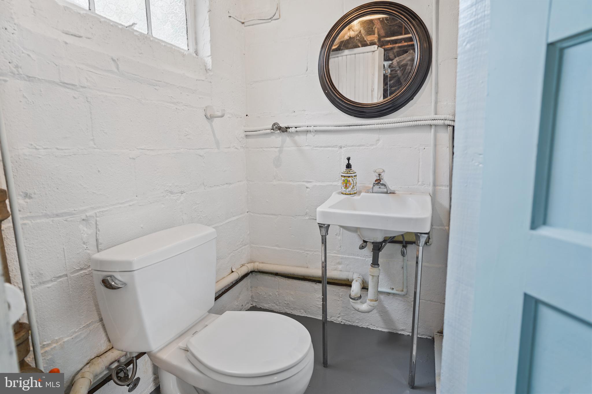 8907 Flower Avenue Silver Spring, MD 20901 - Photo 16 of 20 a bathroom with a sink toilet and a mirror
