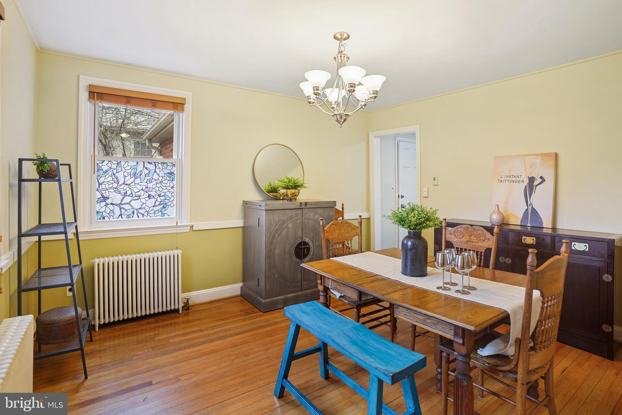 8907 Flower Avenue Silver Spring, MD 20901 - Photo 4 of 20 a dining room with furniture a chandelier and wooden floor