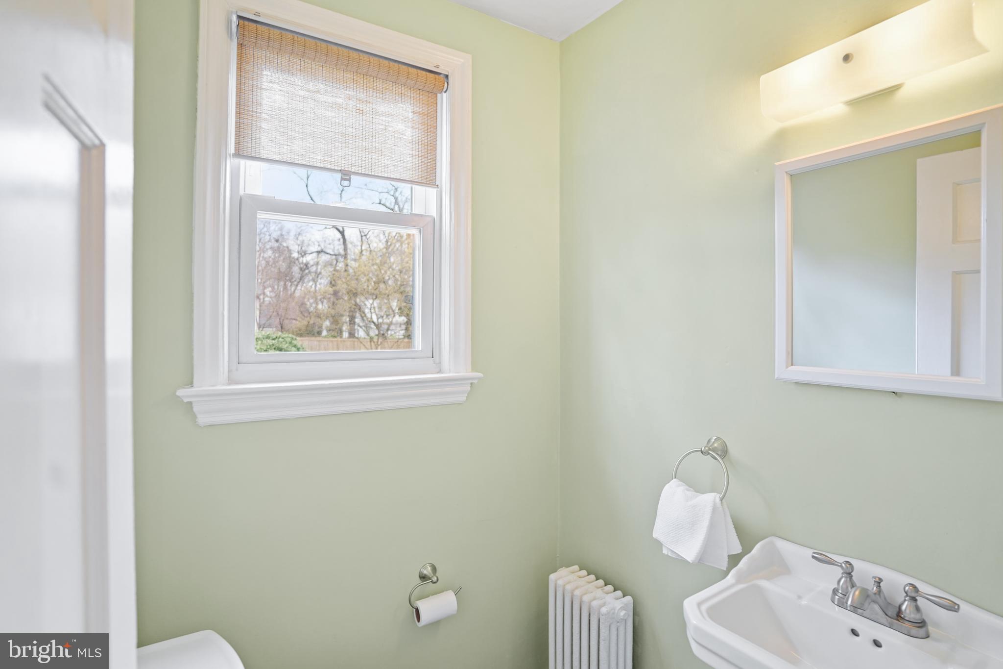8907 Flower Avenue Silver Spring, MD 20901 - Photo 7 of 20 a bathroom with a toilet sink and mirror