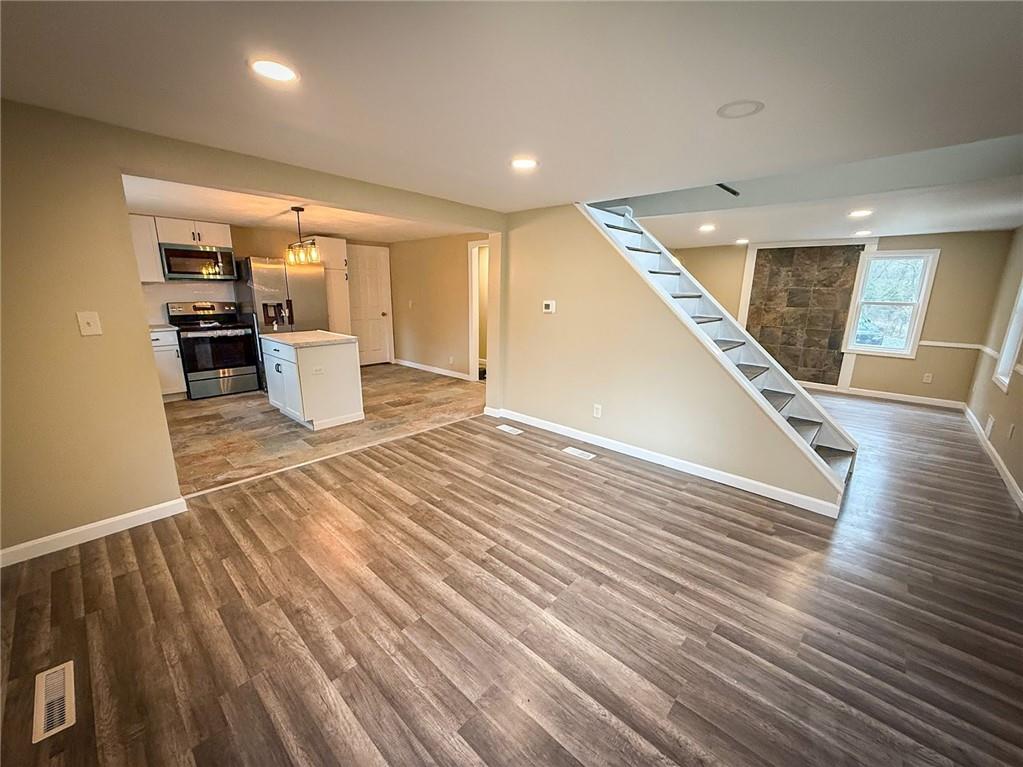 416 Oneida Valley Road Butler, PA 16001 - Photo 23 of 40 a view of a living room and kitchen with furniture and wooden floor