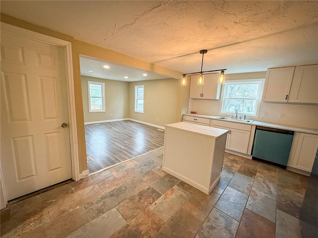 416 Oneida Valley Road Butler, PA 16001 - Photo 27 of 40 a large kitchen with kitchen island granite countertop a stove a sink a refrigerator and white cabinets