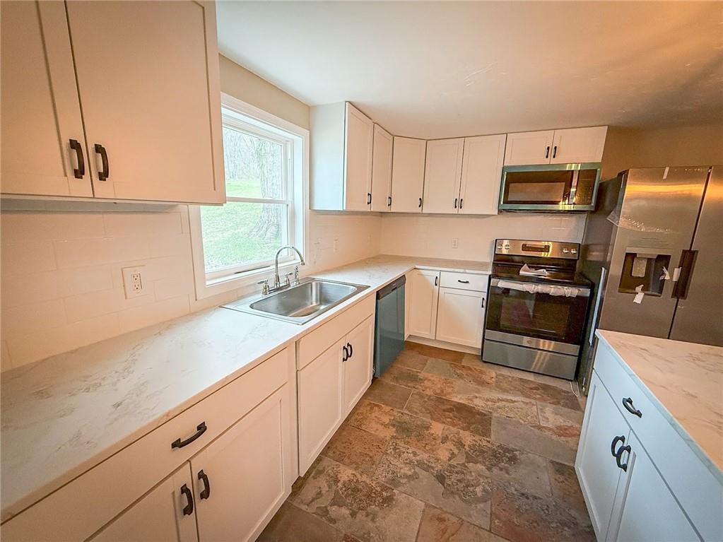 416 Oneida Valley Road Butler, PA 16001 - Photo 30 of 40 a kitchen with granite countertop a sink stainless steel appliances and cabinets
