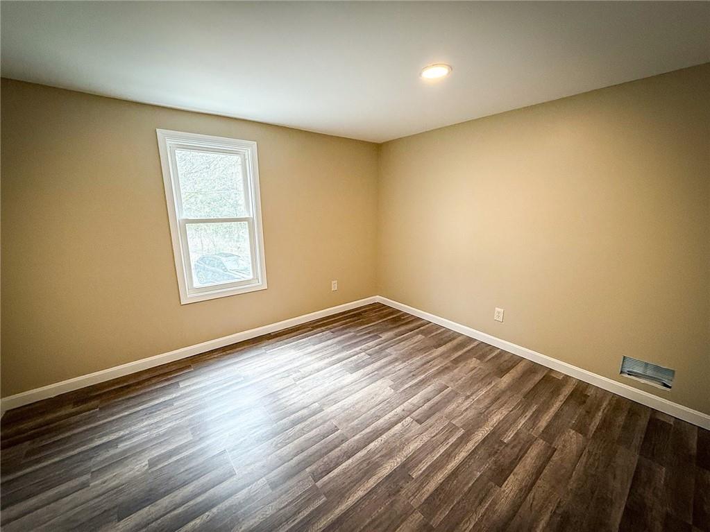 416 Oneida Valley Road Butler, PA 16001 - Photo 6 of 40 an empty room with wooden floor and windows