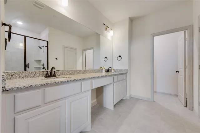 a spacious bedroom with a bed and a window