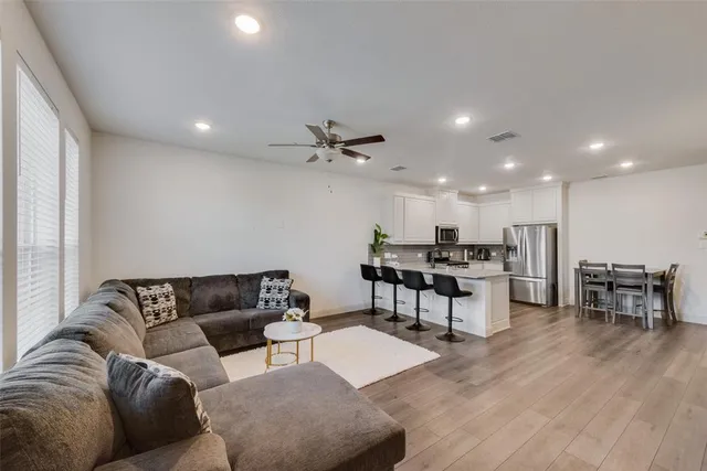 a living room with furniture and kitchen view