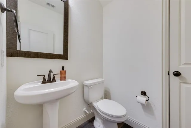 a kitchen with granite countertop a sink appliances a counter space and cabinets