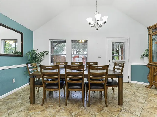 a view of a dining room with furniture and a chandelier