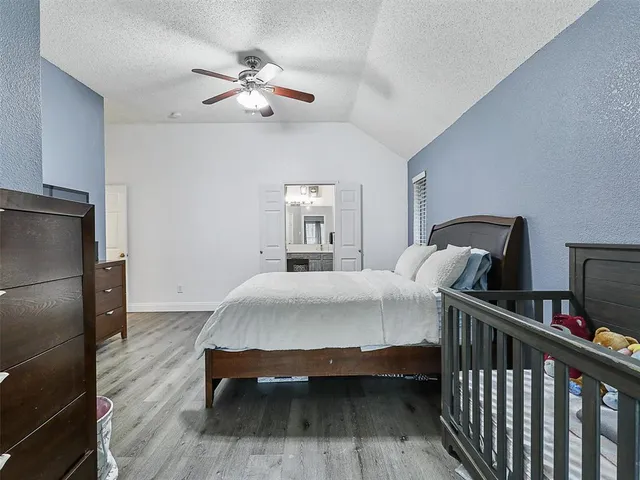 a bedroom with bed and a chandelier