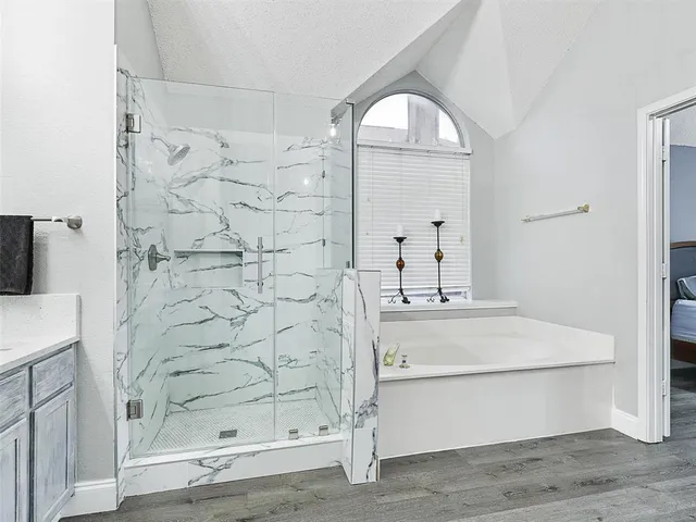a bathroom with a sink a mirror and shower