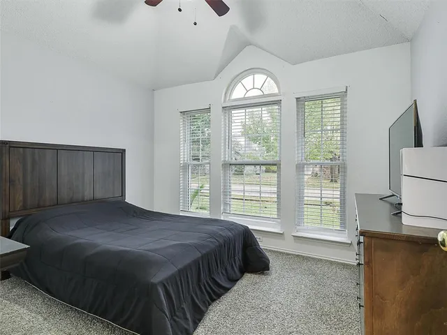 a spacious bedroom with a bed and a window