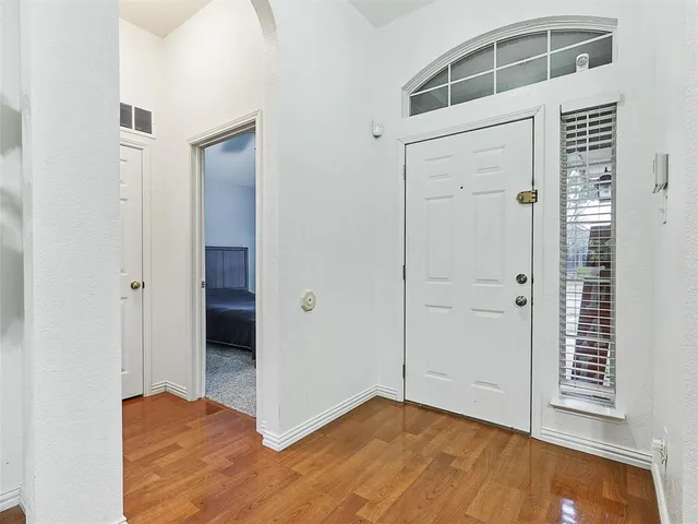 an empty room with wooden floor and closet