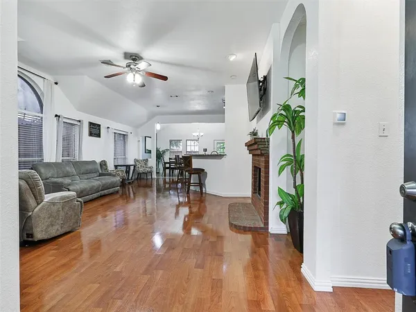 a living room with furniture and a wooden floor