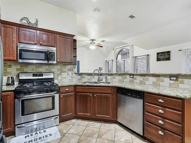 a kitchen with a stove microwave and cabinets