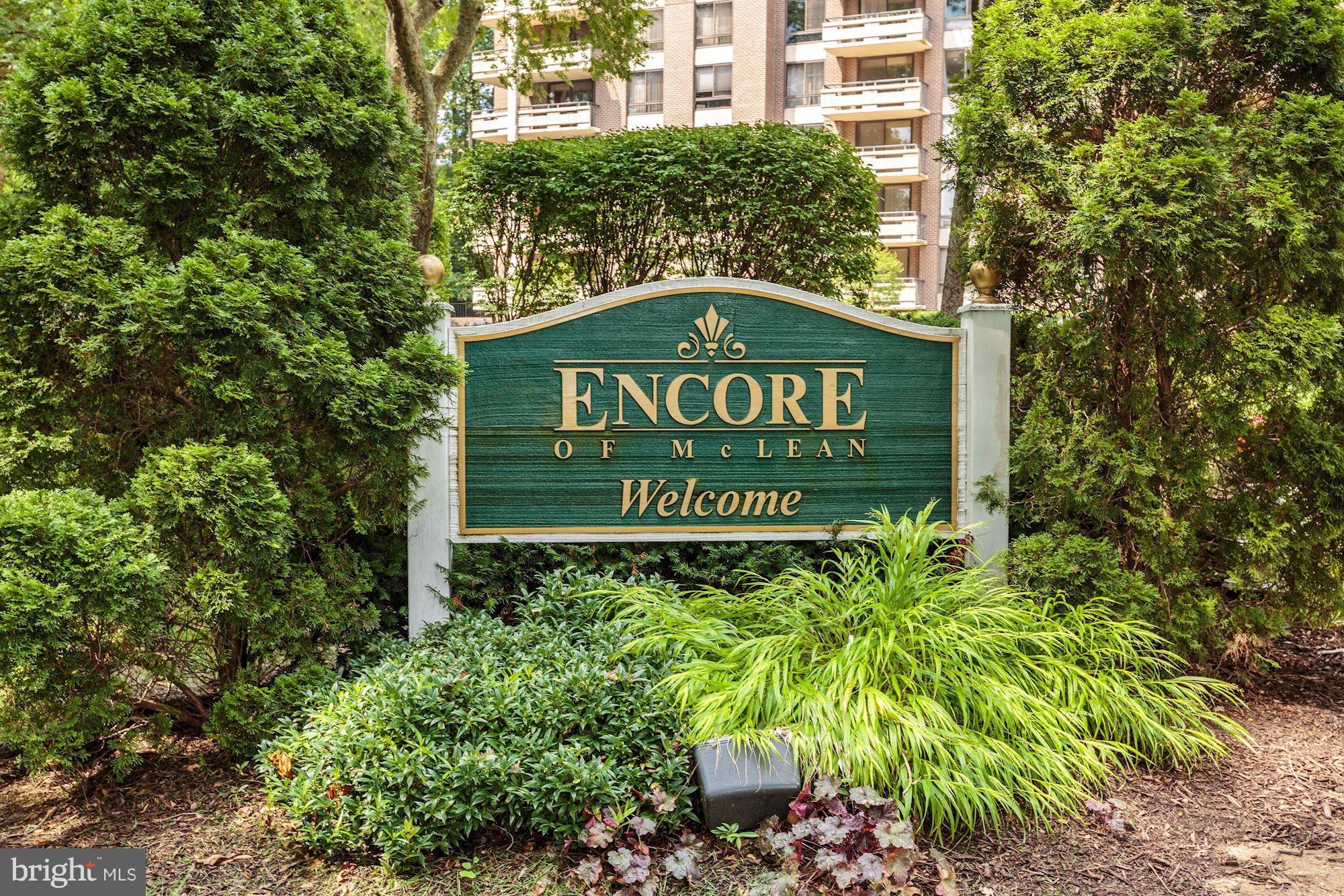 1808 Old Meadow Road, Unit 1403 McLean, VA 22102 - Photo 2 of 30 a sign broad in front of the red tree