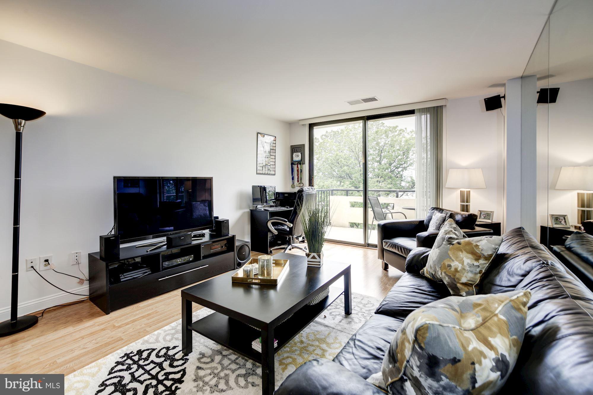 1808 Old Meadow Road, Unit 1403 McLean, VA 22102 - Photo 13 of 30 a living room with furniture and a flat screen tv