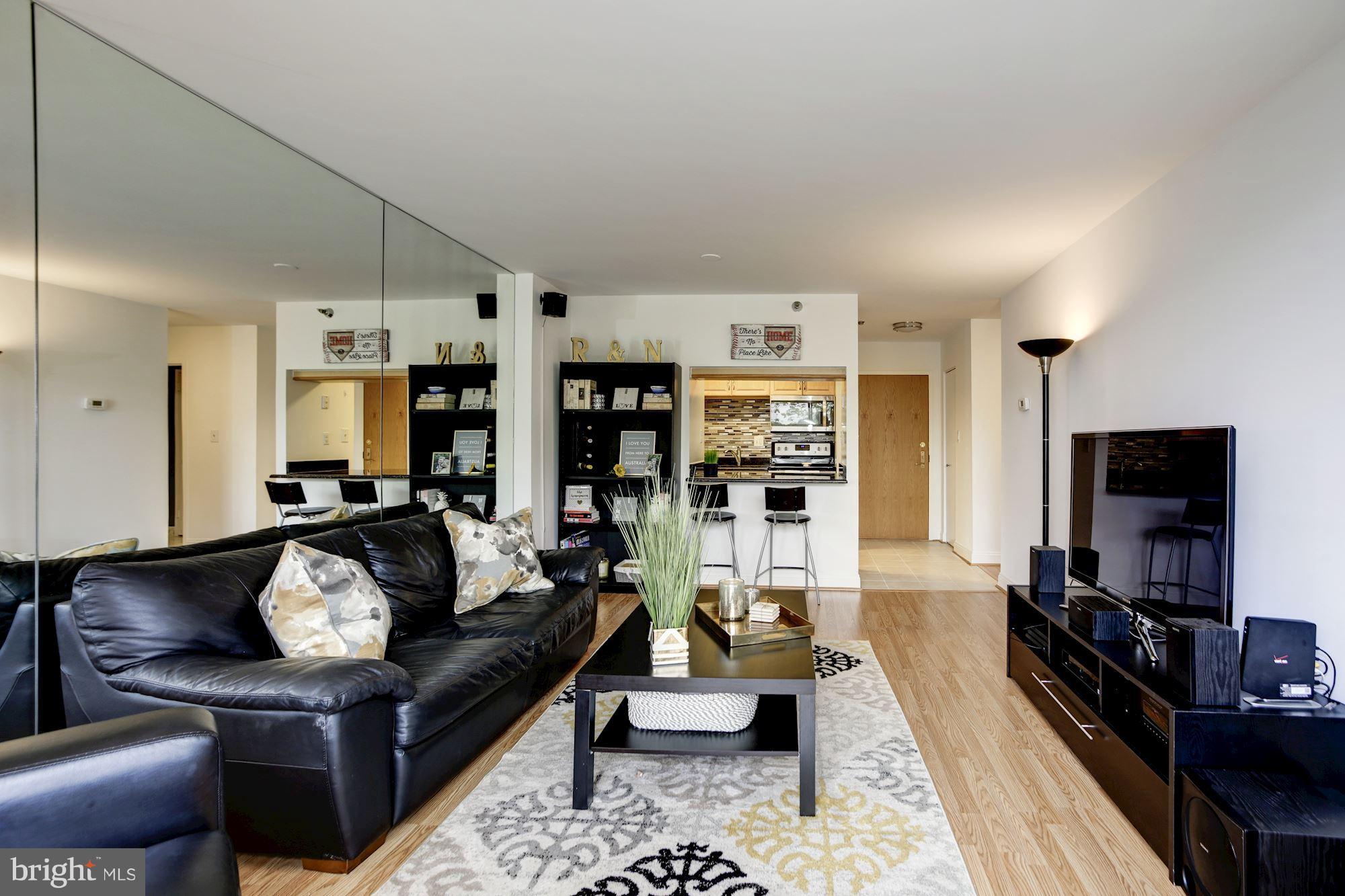 1808 Old Meadow Road, Unit 1403 McLean, VA 22102 - Photo 14 of 30 a living room with furniture and a flat screen tv
