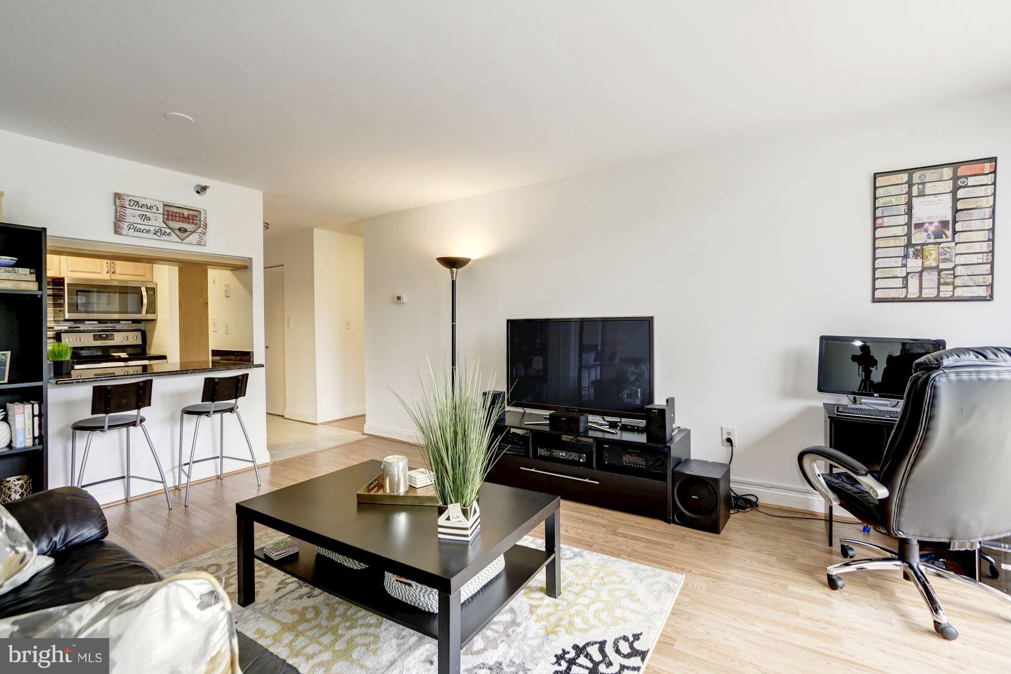 1808 Old Meadow Road, Unit 1403 McLean, VA 22102 - Photo 15 of 30 a living room with furniture and a flat screen tv