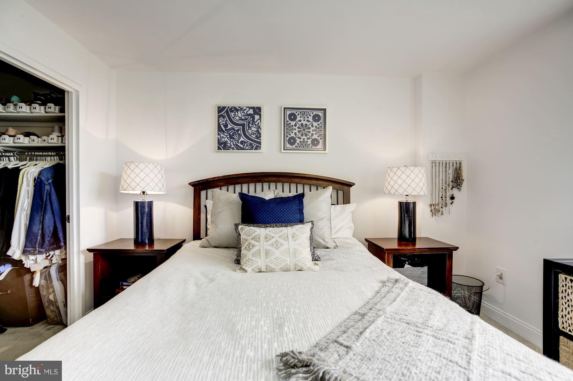 1808 Old Meadow Road, Unit 1403 McLean, VA 22102 - Photo 17 of 30 a bedroom with a bed and a lamp on table