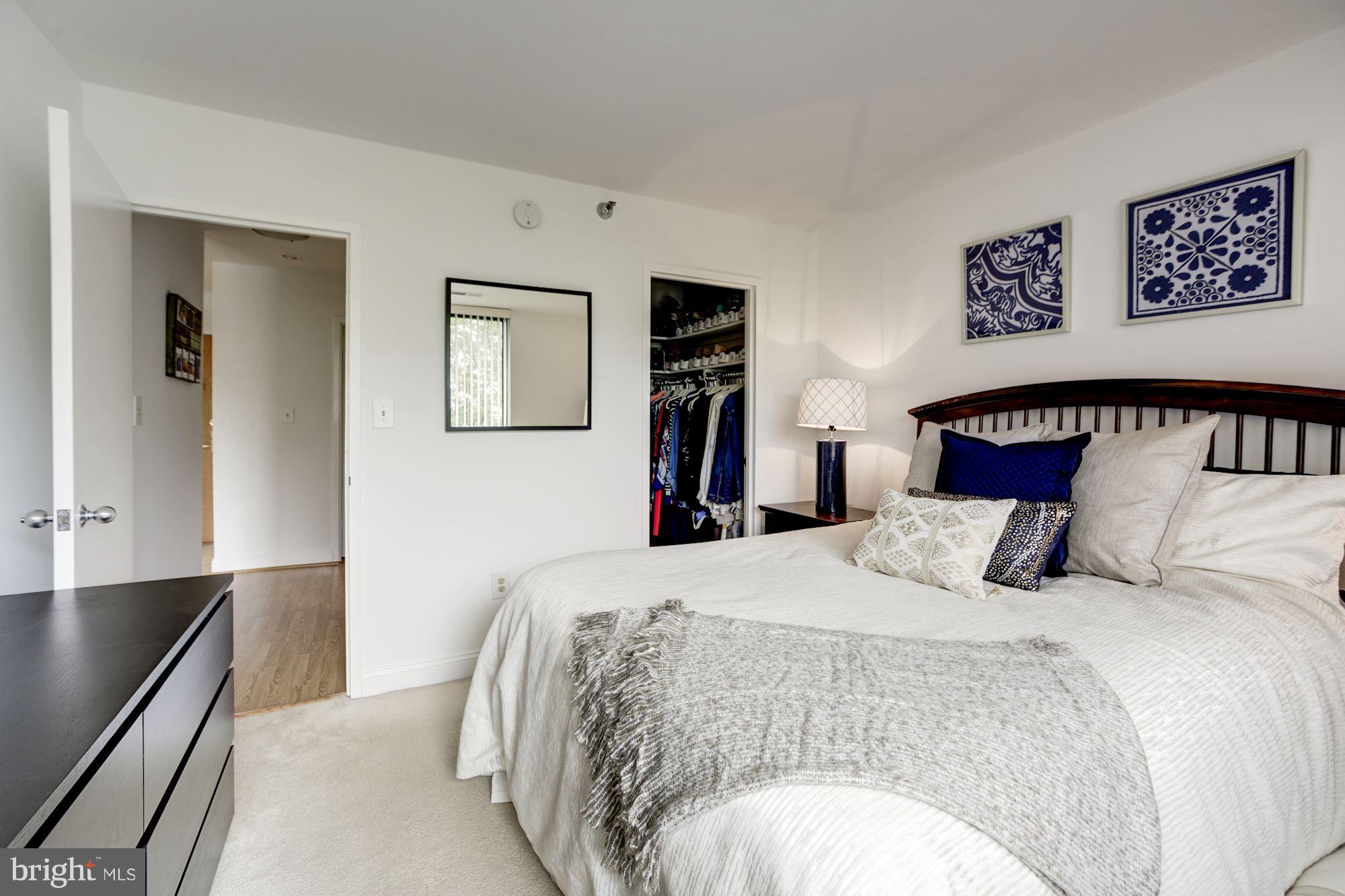 1808 Old Meadow Road, Unit 1403 McLean, VA 22102 - Photo 18 of 30 a bedroom with a large bed and a chandelier
