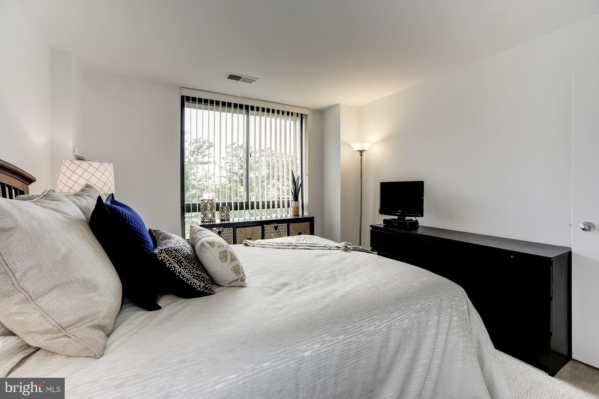 1808 Old Meadow Road, Unit 1403 McLean, VA 22102 - Photo 19 of 30 a bedroom with a bed and a tv