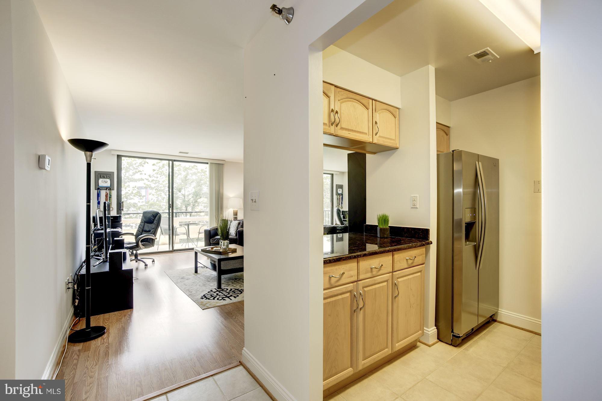 1808 Old Meadow Road, Unit 1403 McLean, VA 22102 - Photo 4 of 30 a kitchen with cabinets and wooden floor