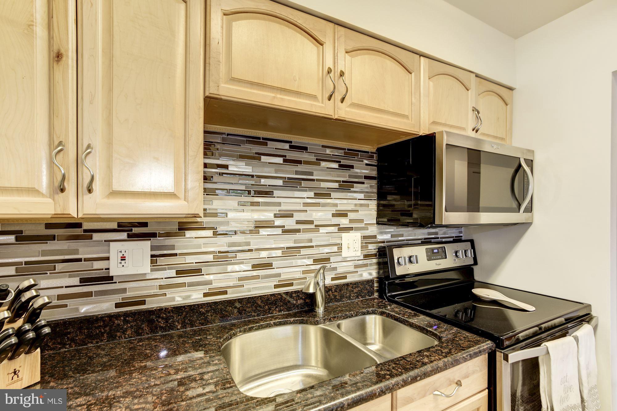 1808 Old Meadow Road, Unit 1403 McLean, VA 22102 - Photo 7 of 30 a kitchen that has a sink and a stove