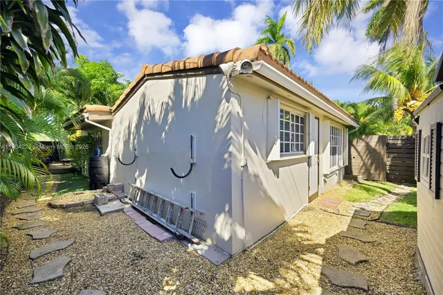 a view of a backyard with potted plants