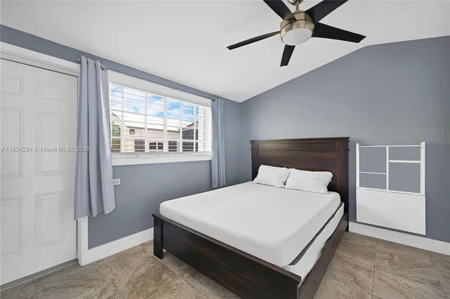 a bedroom with a bed and window