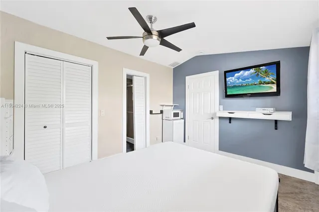 a bedroom with a bed and a flat screen tv