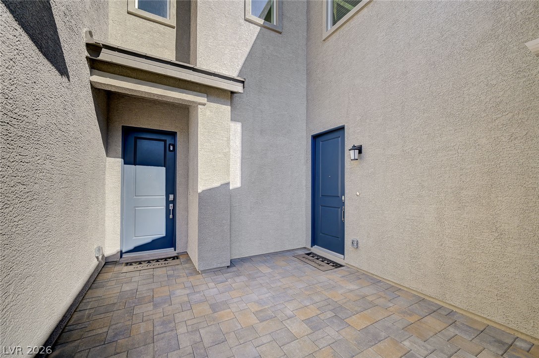 10022 Decano Ridge Street Las Vegas, NV 89141 - Photo 3 of 58 From the Courtyard, enter the main house (center-left) or the attached Next Gen (center-right)
