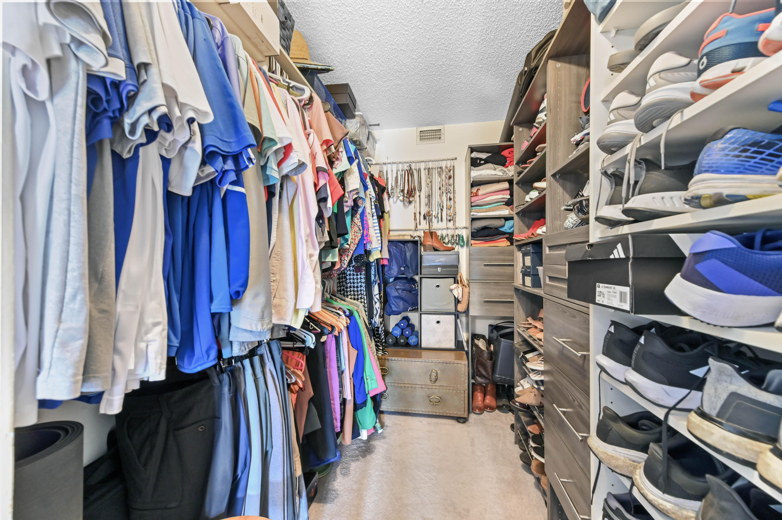 198 Northwest 67th Street, Unit 207 Boca Raton, FL 33487 - Photo 21 of 43 a view of walk in closet with clothes and shoes