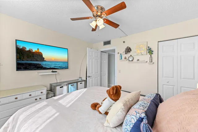 a bedroom with bed and a chandelier