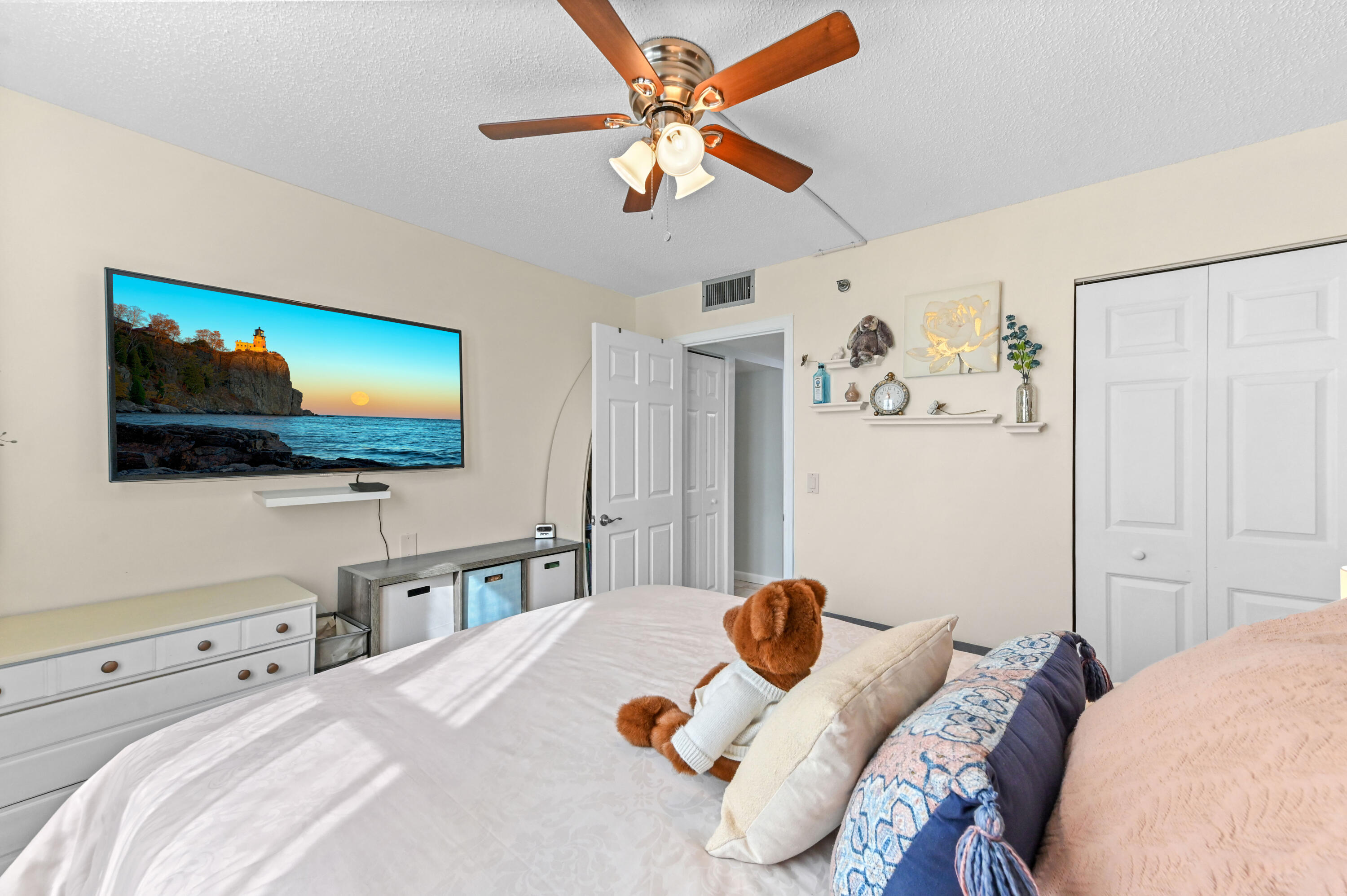 198 Northwest 67th Street, Unit 207 Boca Raton, FL 33487 - Photo 24 of 43 a bedroom with a bed and a flat screen tv