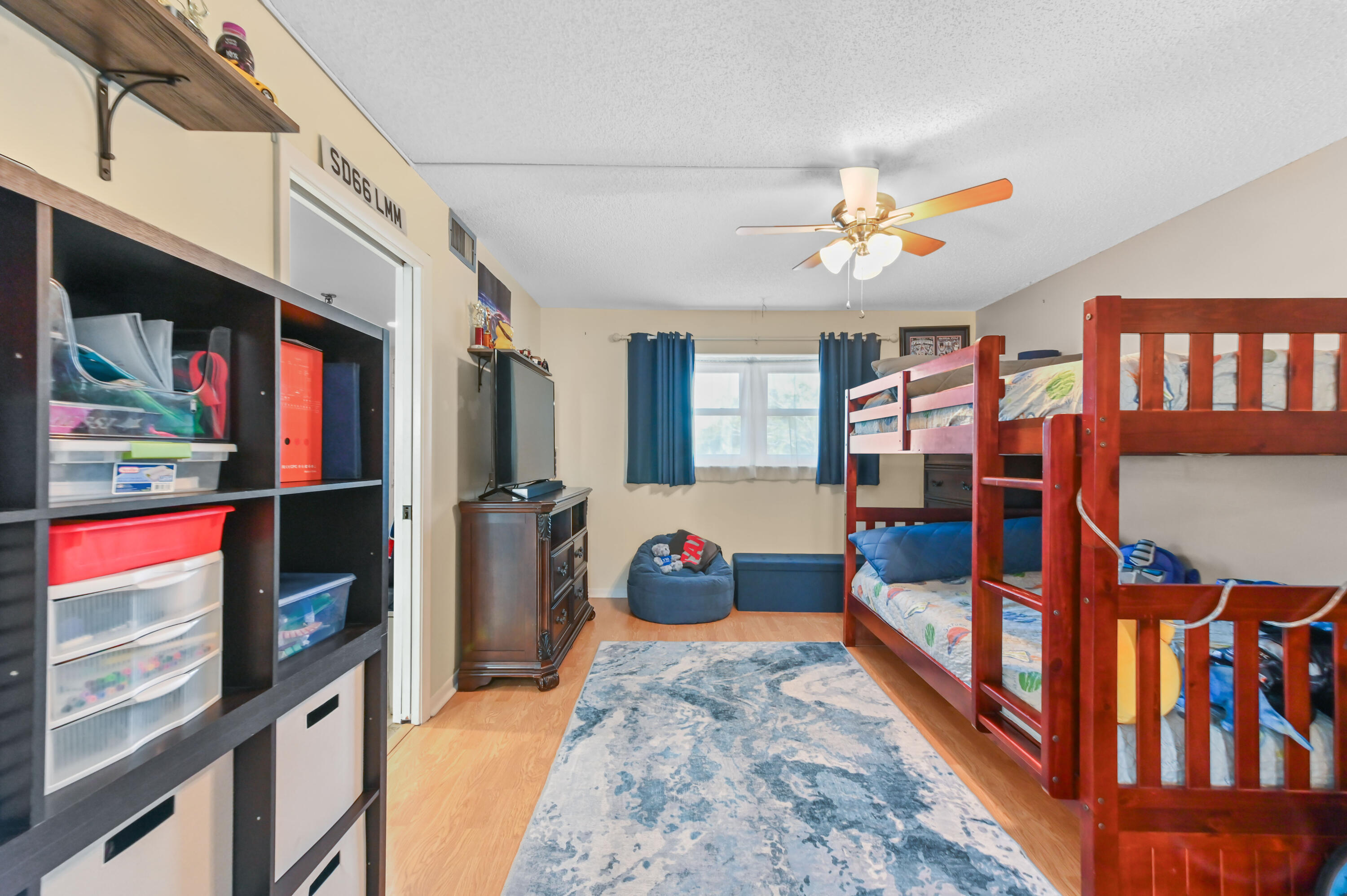 198 Northwest 67th Street, Unit 207 Boca Raton, FL 33487 - Photo 27 of 43 a bedroom with furniture and a chandelier