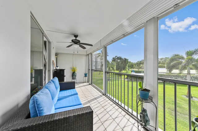 a living room with furniture ceiling fan and a rug
