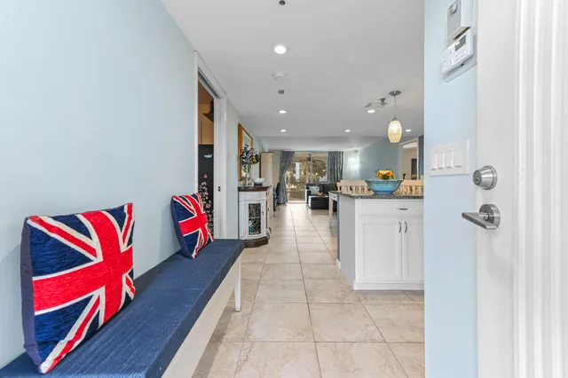 a kitchen with kitchen island granite countertop a sink a counter top space appliances and cabinets