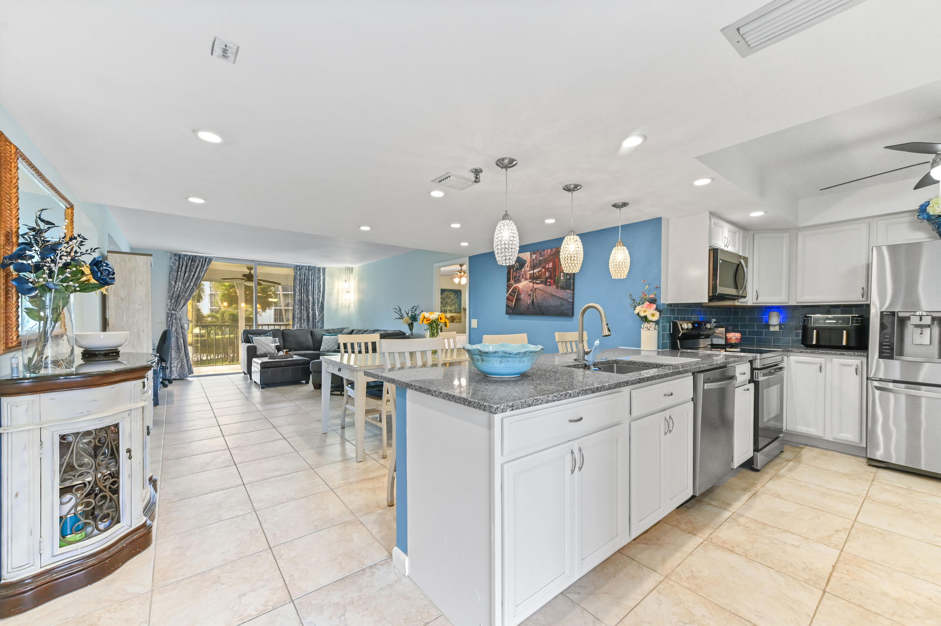 198 Northwest 67th Street, Unit 207 Boca Raton, FL 33487 - Photo 9 of 43 a kitchen with stainless steel appliances granite countertop a sink and cabinets