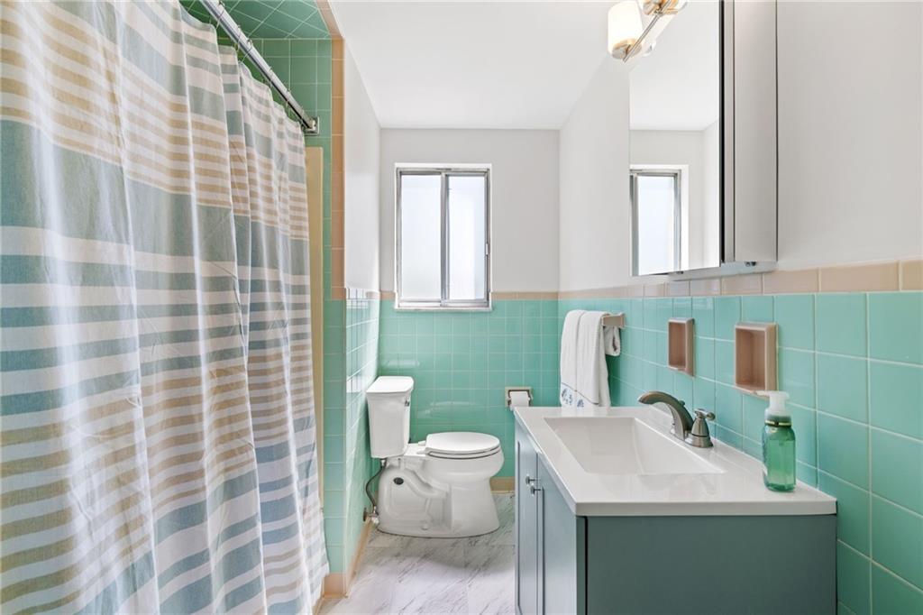 1317 Cathell Road Pittsburgh, PA 15236 - Photo 12 of 32 The main bath has been refreshed with a new floor, vanity, mirror and light.