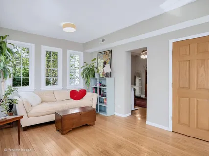 a living room with furniture wooden floor and window