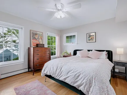 a bedroom with a bed dresser and a window
