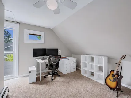 a view of a workspace with furniture and gym equipment