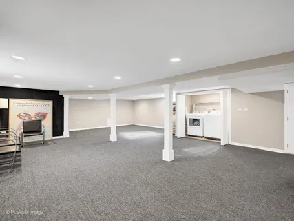 an empty room with a fireplace and window