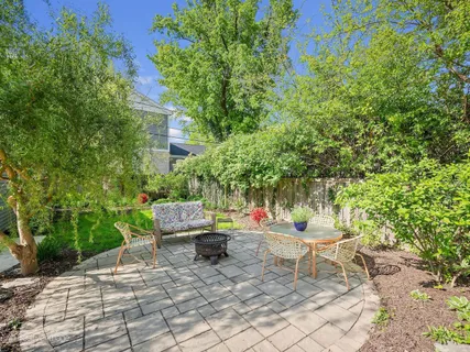 a backyard of a house with outdoor seating