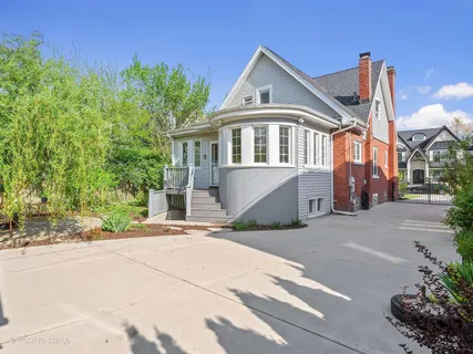 a front view of a house with a garden