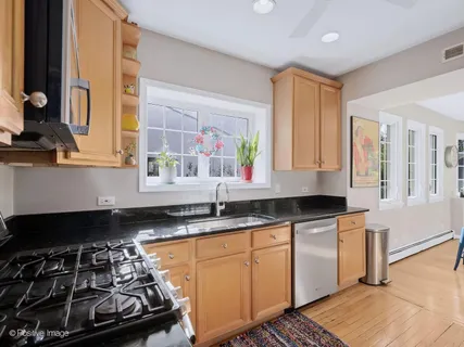 a kitchen with granite countertop a stove a sink and a granite counter tops