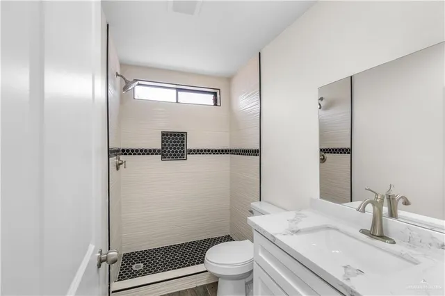 an aerial view of a house with a garden and lake view