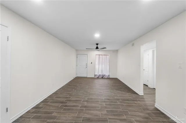 a kitchen with a sink a refrigerator a stove and white cabinets