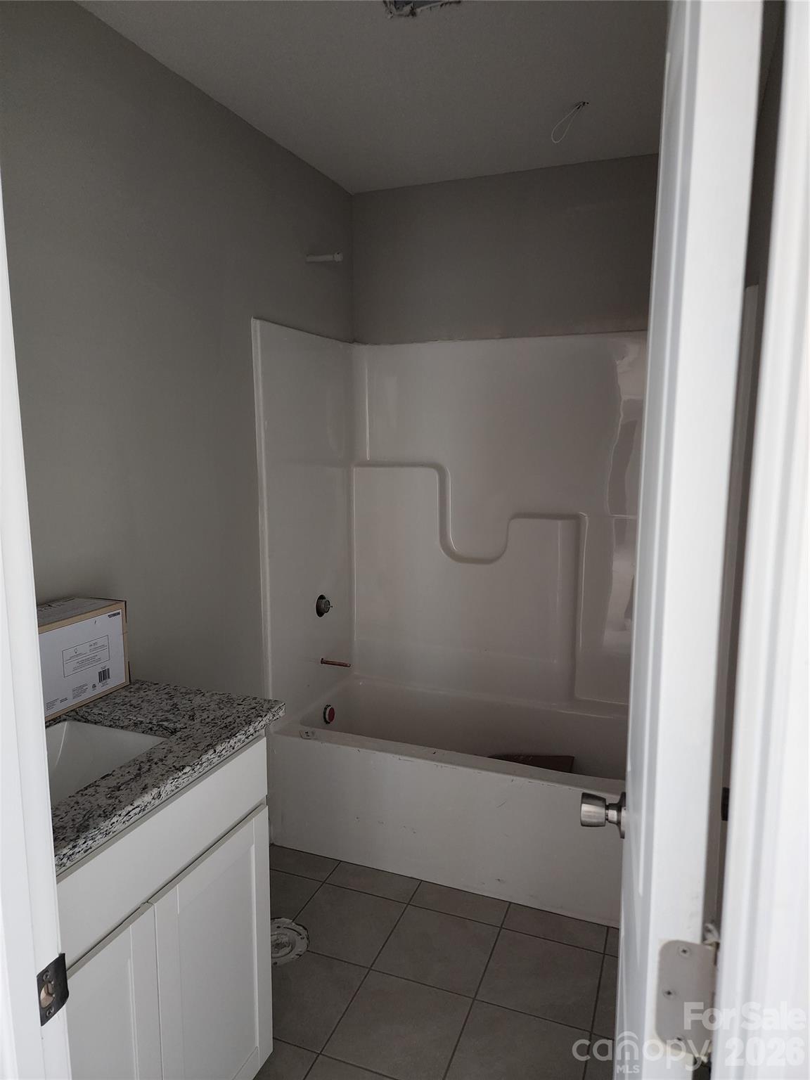 5405 Springs Road, Unit 3 Conover, NC 28613 - Photo 24 of 28 a bathroom with a granite countertop sink a toilet and bathtub