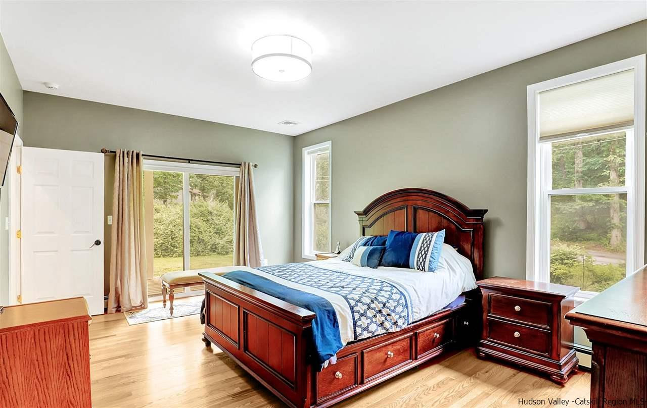 194 Harry Wells Road Saugerties, NY 12477 - Photo 24 of 35 a bedroom with a bed and a dresser next to a window