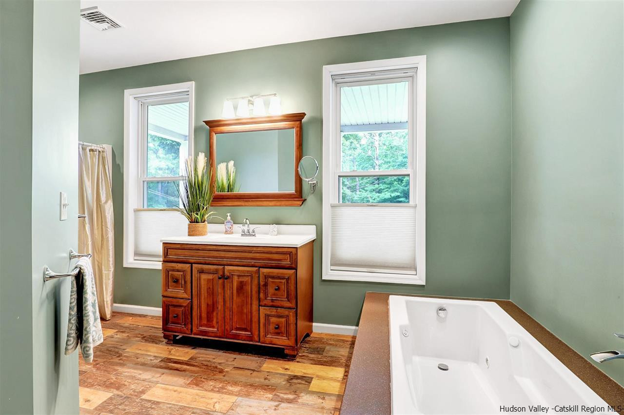 194 Harry Wells Road Saugerties, NY 12477 - Photo 25 of 35 a bathroom with a tub sink and mirror